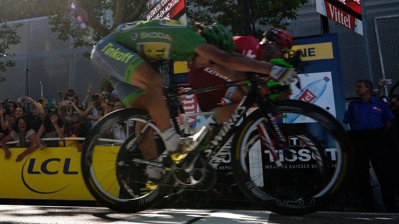 Peter Sagan (front), wearing the best sprinter's green jersey crosses the finish line a whisker ahead of Alexander Kristoff