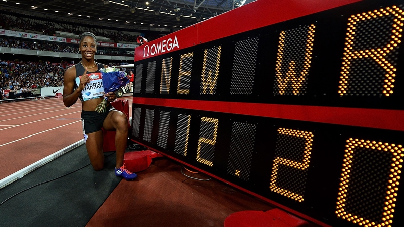 Kendra Harrison mullposes beside her record-breaking time