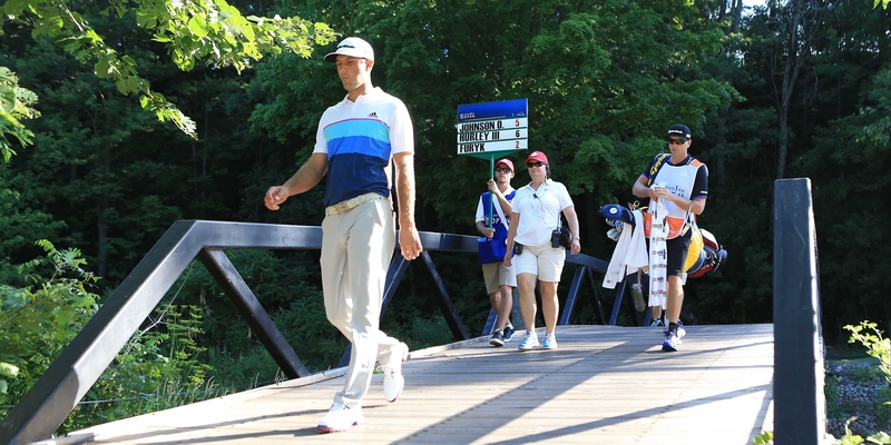 Dustin Johnson makes his way to the 12th tee