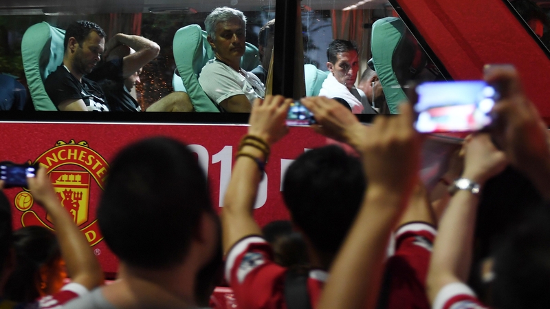 Jose Mourinho looks on as fans flock to the team bus