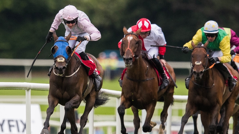 Barry Browne pushes Swamp Fox (l) out to win the opening day higlight at Ballybrit