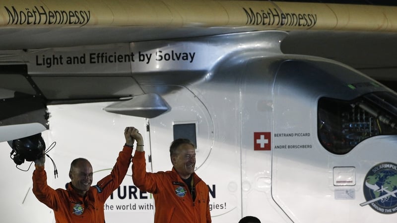 Bertrand Piccard (L) and André Borschberg are greeted upon Piccard's arrival in Abu Dhabi