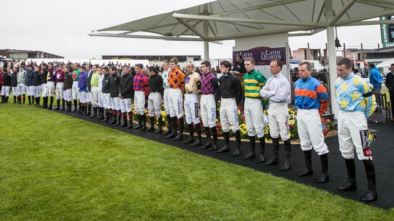 Jockeys stand for a minutes silence in memory of JT McNamara