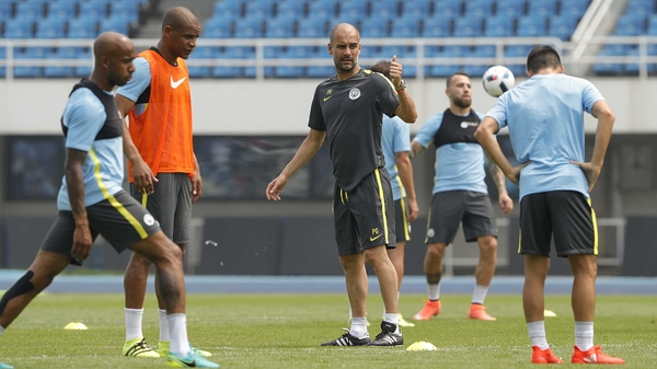Pep Guardiola takes training at Olympic Sports Center Stadium in Beijing