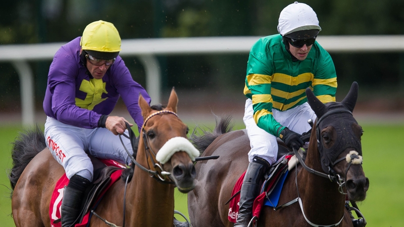 Mark Walsh onboard All The Answers, right, clears the last fence on his way to winning