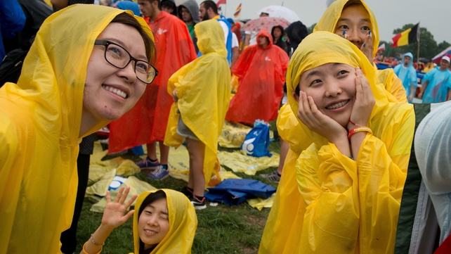 Pilgrims wait for Pope Francis at the opening ceremony of the World Youth Day at Blonia Park in Krakow