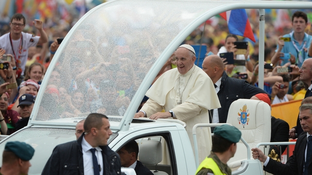 Francis greets people from his popemobile on his way to Blonia Park