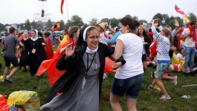 Pilgrims celebrate after a welcome ceremony for Pope Francis