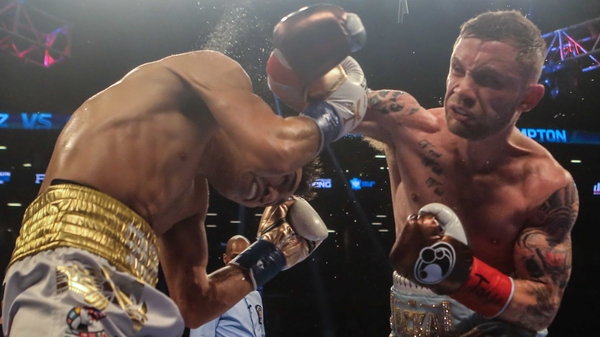 Carl Frampton (R) is a two-weight world champion after securing the featherweight title in New York