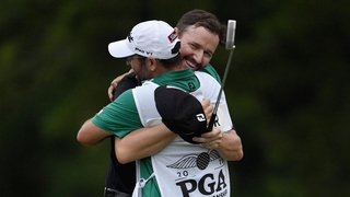 Jimmy Walker celebrates with his caddie on the 18th green