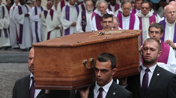 Pallbearers carry the coffin of the priest Jacques Hamel as they enter in Rouen's cathedral