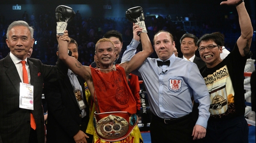 Amnat Ruenroeng celebrates after beating China's Zou Shiming in Macau to become the IBF world flyweight champion in March 2015