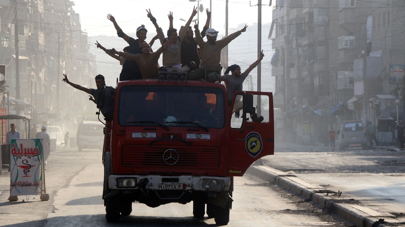 Syrian civil defence volunteers, known as the White Helmets, celebrate after rebels said they have broken a three-week government siege on Aleppo