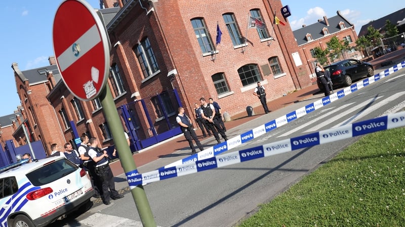 Police stand as they secure the area around a police building in the southern Belgian city of Charleroi following a machete attack