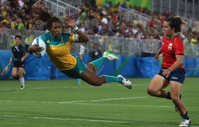 Ellia Green of Australia soars over for a try against as Spain's Patricia Garcia looks on during the Women's quarter-final