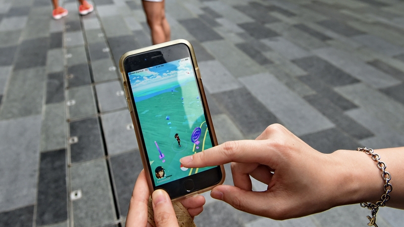 The game involves looking for virtual characters overlaid on real-world scenes