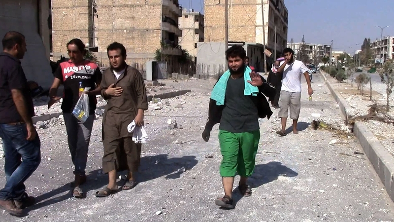 Syrians are seen returning to their homes in al-Sirb neighbourhood in Manbij