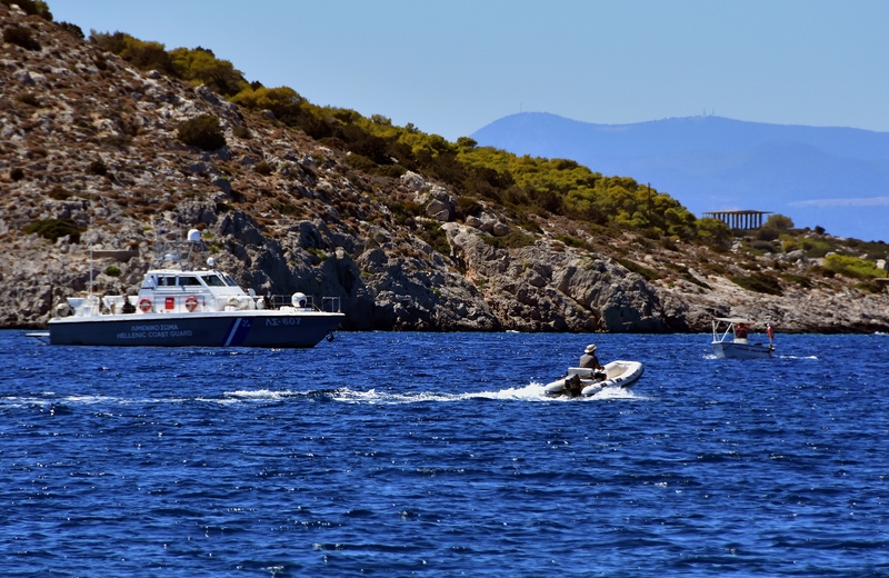 Coast guard officers and fishermen search for missing passengers after the crash
