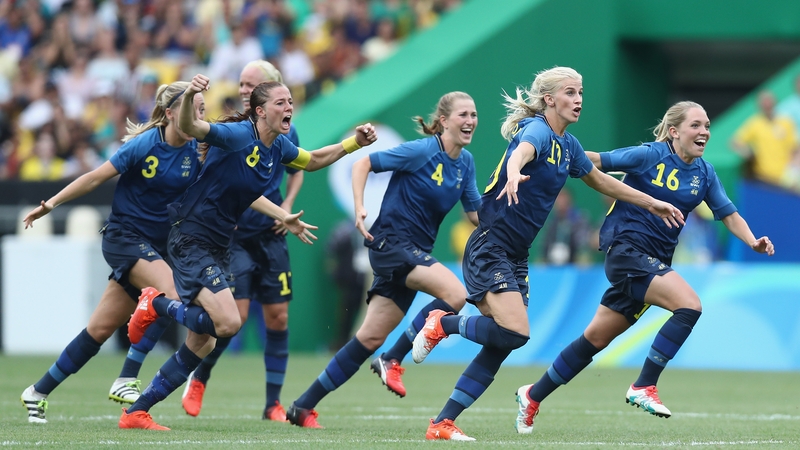 The Swedish players celebrate after Lisa Dahlkvist scored the decisive penalty