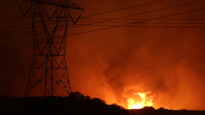 Flames from the Blue Cut Fire threaten power lines north of Los Angeles