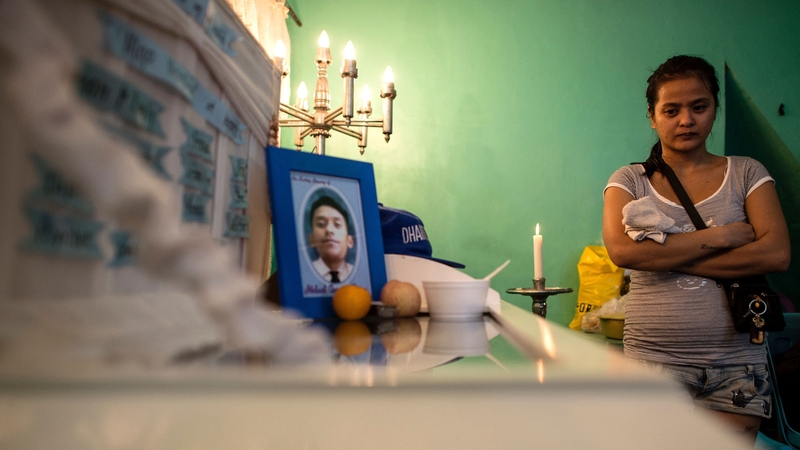 Jennilyn Olayres grieves for her partner Michael Siaron after he was found dead in Manila with a cardboard poster on his body saying 'drug pusher'