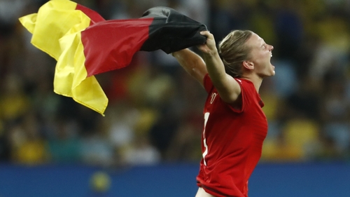 Germany's striker Alexandra Popp runs with a flag as she celebrates her team's victory over Sweden