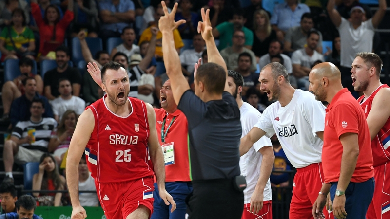 Serbian players and management celebrate during their semi-final with Australia