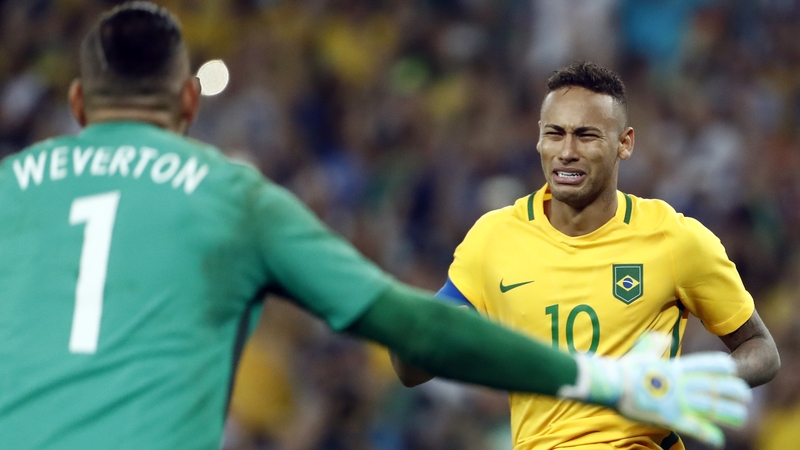 Neymar celebrates scoring the winning goal with Brazil's goalkeeper Weverton Pereira da Silva