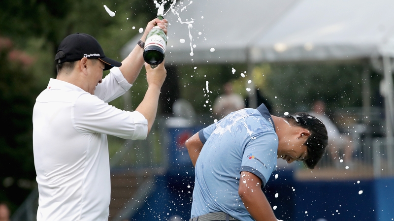 Rampert Sim pours champagne on Si Woo Kim