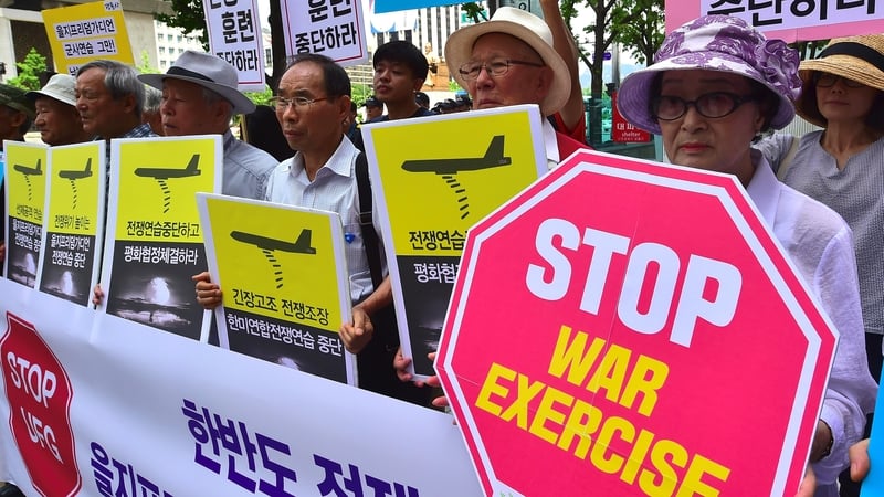 Protesters near the US embassy in Seoul call for an end to the drills