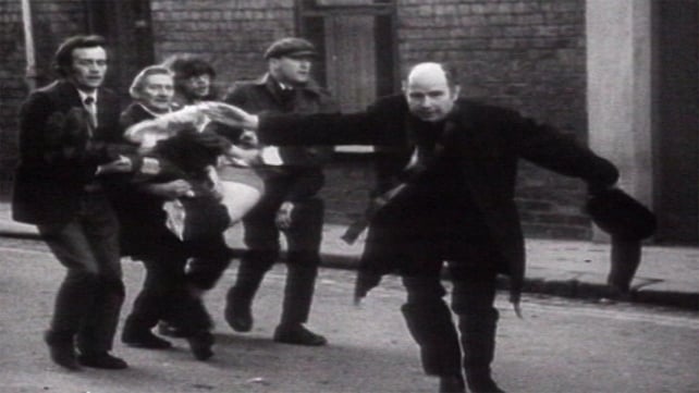 At 4.10pm soldiers opened fire on people in the area of Rossville flats. This photo shows Fr Edward Daly leading a group of people carrying Jackie Duddy, who was shot in the car park of the flats