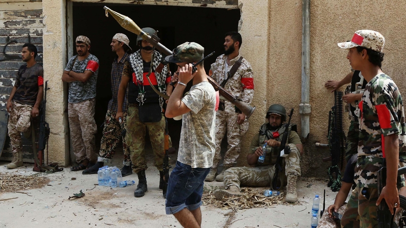 Members of the forces loyal to Libya's UN-backed Government of National Accord (GNA) prepare their weapons as they gather in the coastal city of Sirte