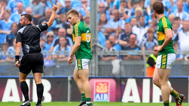 Referee David Gough shows a yellow card to Peter Crowley