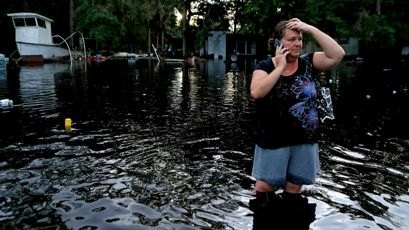 Resident Lynne Garrett surveys the damage outside her home in St. Marks, Florida