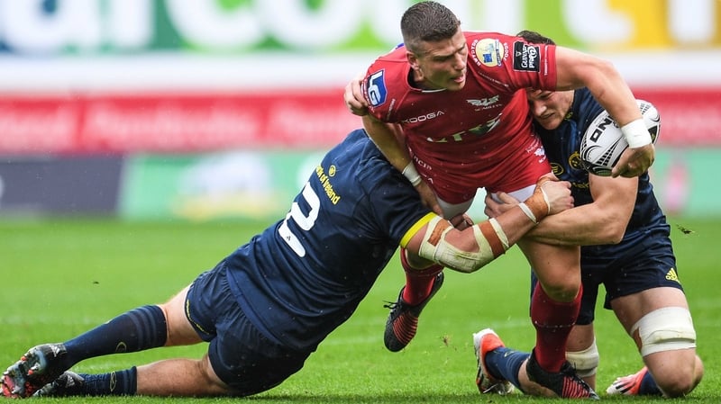 Scarlets' Scott Williams is tackle by Niall Scannell and Jack O'Donoghue of Munster