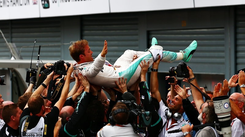 Rosberg is hoisted aloft by his Mercedes team