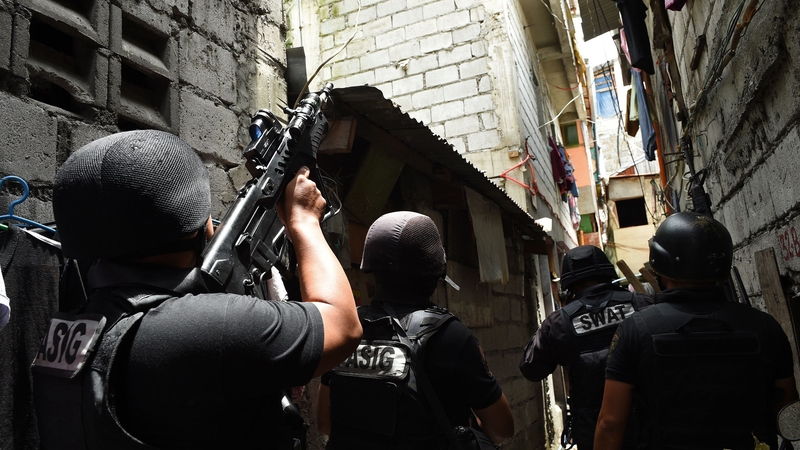 Philippine police SWAT personnel carry out a search of residences in Pasig City, Manila