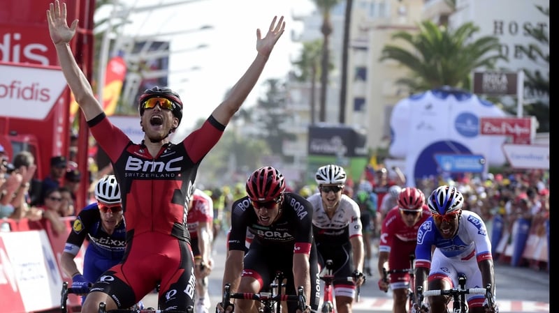 Jean-Pierre Drucker (L) crosses the finish line