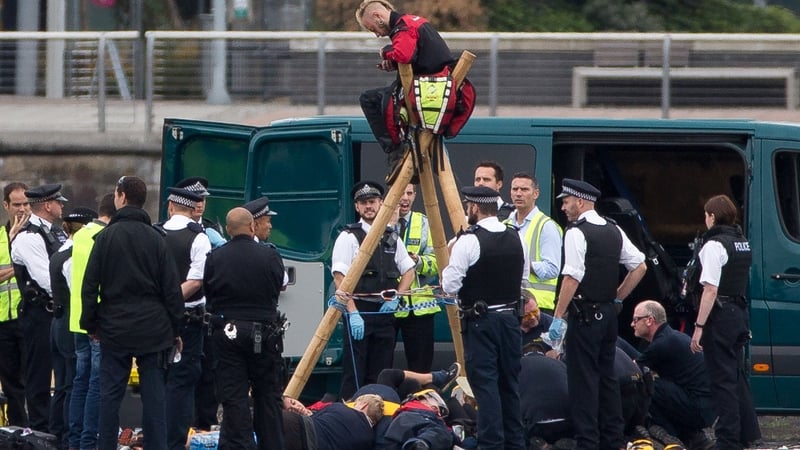 Protesters locked themselves to a tripod on the runway