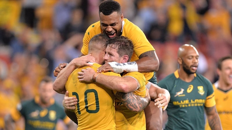 Bernard Foley is congratulated by team-mates after scoring the winning try for the Wallabies