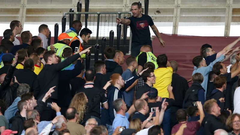 West Ham supporters gesture towards Watford fans