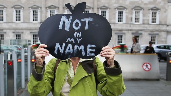A woman protests the Apple state aid ruling