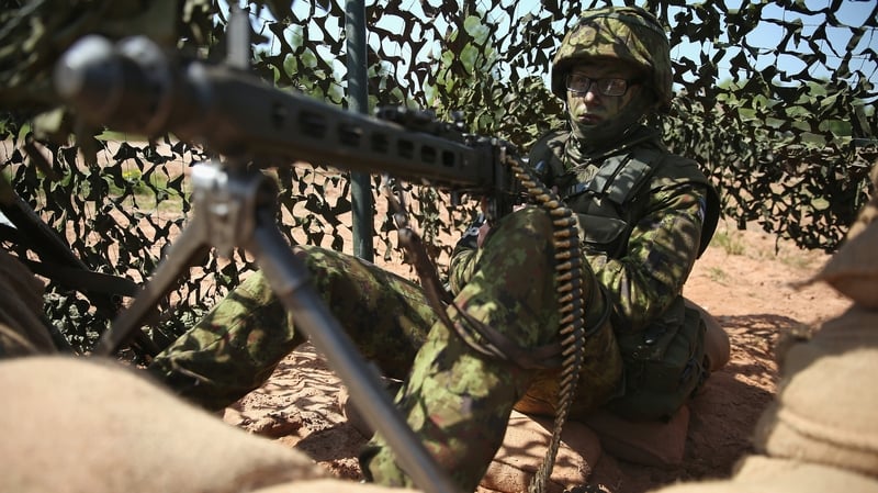 An Estonian soldier mans a machine gun during the annual NATO military exercises near Helme, Estonia