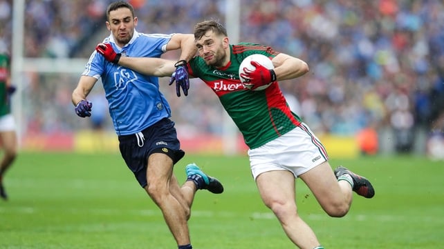 Mayo's Aidan O'Shea holds off the attentions of James McCarthy