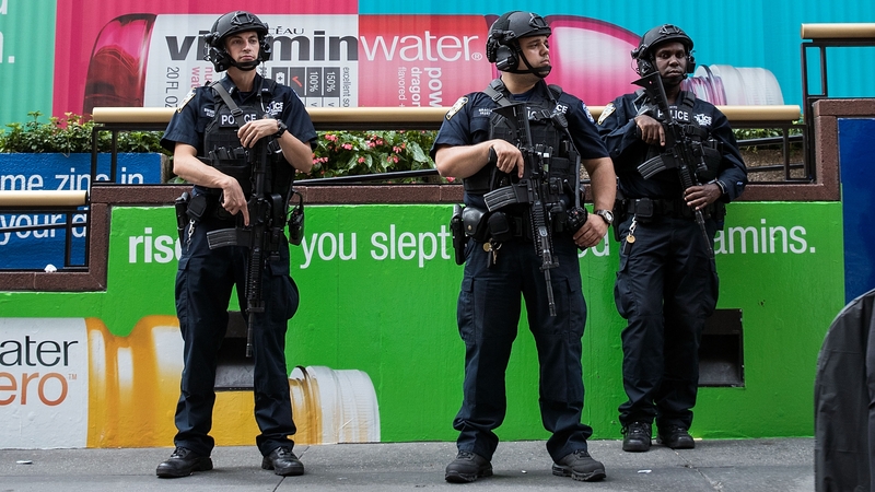 Members of the NYPD stand guard near Penn Station in New York