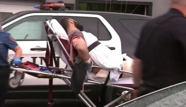 The suspect had a bloodied bandage on his right arm when he was taken away in an ambulance