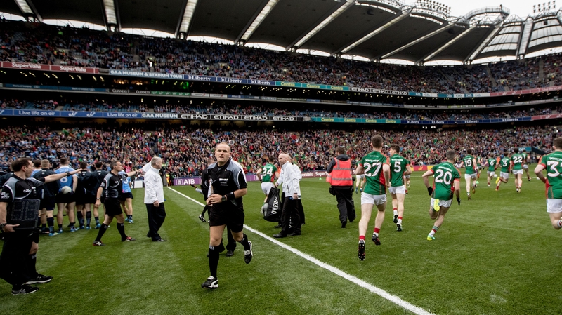 Dublin and Mayo players are separated after they both emerge from the tunnel at the same time
