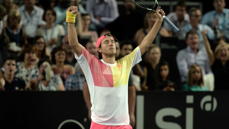 Lucas Pouille raises his hands in victory