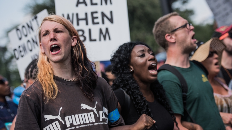 Demonstrators form a human chain outside a stadium ahead of an NFL football game in Charlotte today