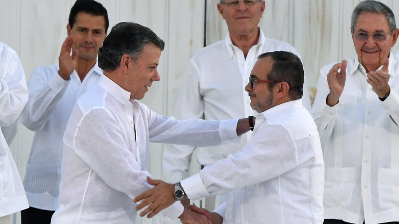 Colombian President Juan Manuel Santos and FARC leader Timochenko shake hands at last week's accord before it was defeated at the polls